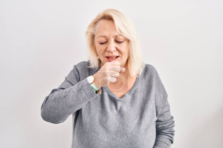Photo for Middle age caucasian woman standing over white background feeling unwell and coughing as symptom for cold or bronchitis. health care concept. - Royalty Free Image