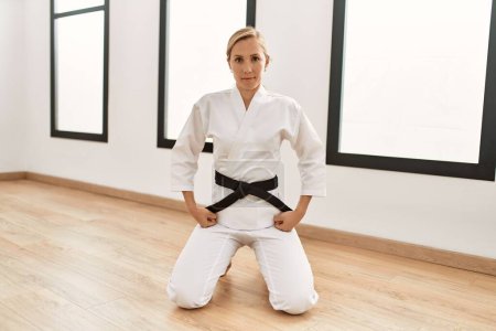 Photo for Young caucasian woman training karate at sport center - Royalty Free Image