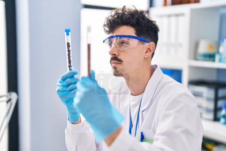 Photo for Young caucasian man scientist holding test tubes at laboratory - Royalty Free Image