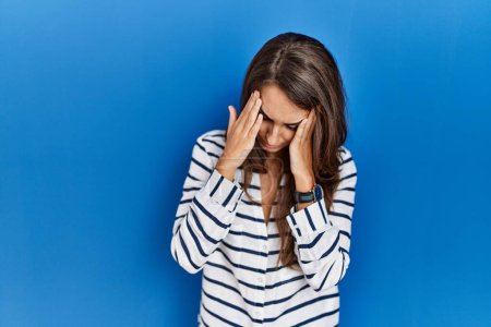 Photo for Young hispanic woman standing over blue isolated background with sad expression covering face with hands while crying. depression concept. - Royalty Free Image