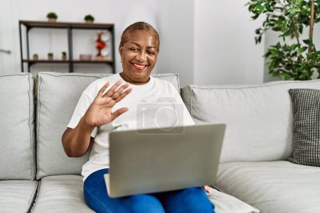 Photo for Senior african american woman smiling confident having video call at home - Royalty Free Image