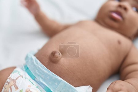 Photo for African american baby belly button at bedroom - Royalty Free Image