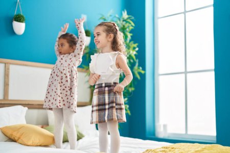 Photo for Two kids smiling confident dancing on bed at bedroom - Royalty Free Image
