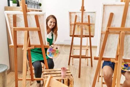 Photo for Mother and daughter smiling confident drawing at art studio - Royalty Free Image