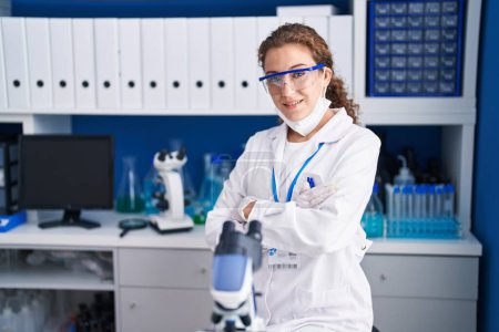 Photo for Young caucasian woman working at scientist laboratory happy face smiling with crossed arms looking at the camera. positive person. - Royalty Free Image