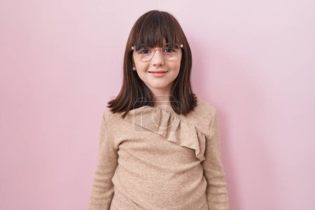 Photo for Little hispanic girl wearing glasses looking positive and happy standing and smiling with a confident smile showing teeth - Royalty Free Image