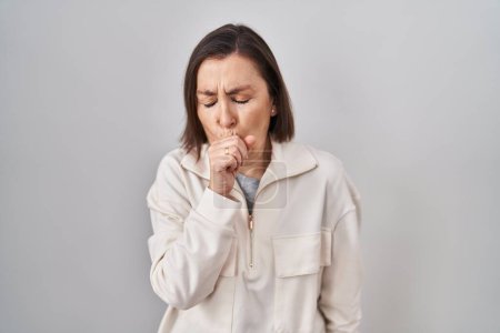 Photo for Middle age hispanic woman standing over isolated background feeling unwell and coughing as symptom for cold or bronchitis. health care concept. - Royalty Free Image