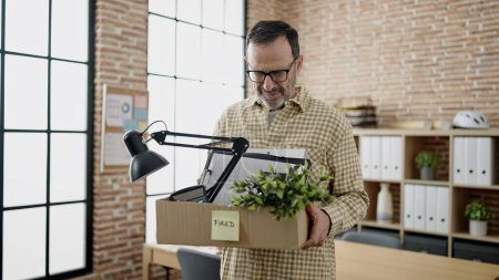 Photo for Middle age man business worker dismissed holding cardboard box at office - Royalty Free Image