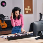 Young caucasian woman musician having dj session at music studio