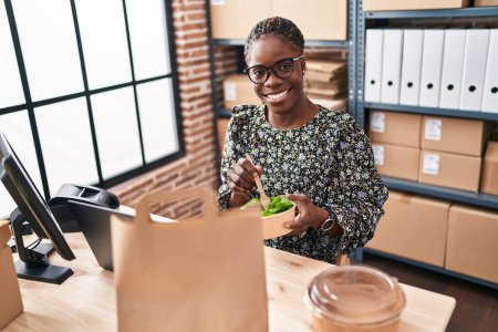Photo for African american woman ecommerce business worker eating salad at office - Royalty Free Image