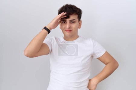 Téléchargez les photos : Young non binary man wearing casual white t shirt worried and stressed about a problem with hand on forehead, nervous and anxious for crisis - en image libre de droit