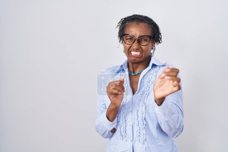 Photo for African woman with dreadlocks standing over white background wearing glasses disgusted expression, displeased and fearful doing disgust face because aversion reaction. with hands raised - Royalty Free Image