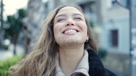 Photo for Young beautiful hispanic woman breathing with closed eyes at street - Royalty Free Image