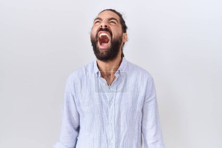 Photo for Hispanic man with beard wearing casual shirt angry and mad screaming frustrated and furious, shouting with anger. rage and aggressive concept. - Royalty Free Image