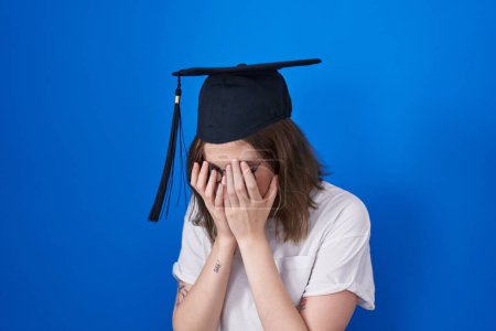 Photo for Blonde caucasian woman wearing graduation cap with sad expression covering face with hands while crying. depression concept. - Royalty Free Image