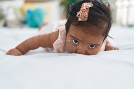 Photo for African american baby lying on bed with relaxed expression at bedroom - Royalty Free Image