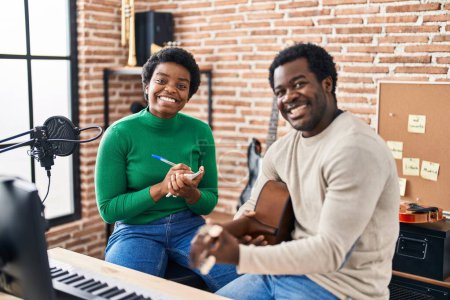 Photo for African american man and woman music group compising song at music studio - Royalty Free Image