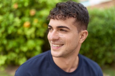 Photo for Young hispanic man smiling confident looking to the side at park - Royalty Free Image