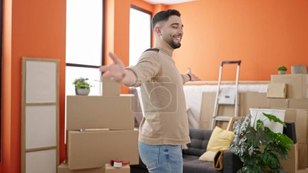 Photo for Young arab man smiling confident standing with arms open at new home - Royalty Free Image