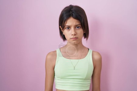 Photo for Young girl standing over pink background depressed and worry for distress, crying angry and afraid. sad expression. - Royalty Free Image