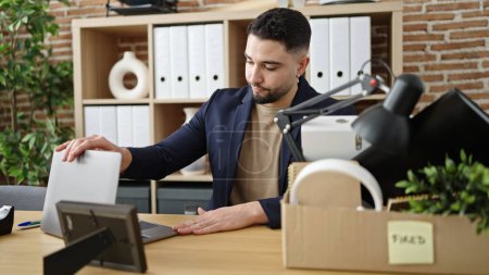 Photo for Young arab man business worker unemployed closing laptop at office - Royalty Free Image
