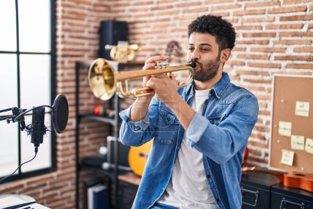 Photo for Young arab man musician playing trumpet at music studio - Royalty Free Image