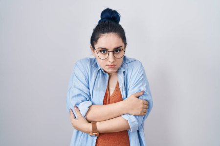 Photo for Young modern girl with blue hair standing over white background shaking and freezing for winter cold with sad and shock expression on face - Royalty Free Image