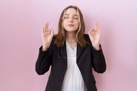 Photo for Young caucasian business woman wearing black jacket relaxed and smiling with eyes closed doing meditation gesture with fingers. yoga concept. - Royalty Free Image
