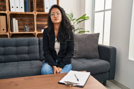 Téléchargez les photos : Young asian woman at consultation office looking sleepy and tired, exhausted for fatigue and hangover, lazy eyes in the morning. - en image libre de droit