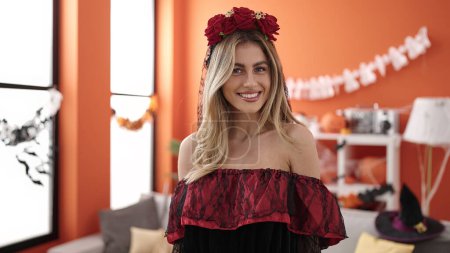 Téléchargez les photos : Young blonde woman wearing katrina costume having halloween party at home - en image libre de droit