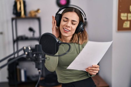 Photo for Young beautiful hispanic woman musician smiling confident singing song at music studio - Royalty Free Image