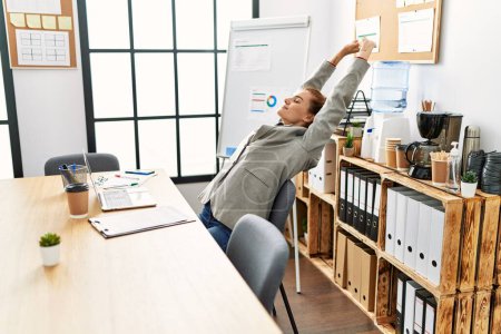 Photo for Young woman business worker stretching arms at office - Royalty Free Image