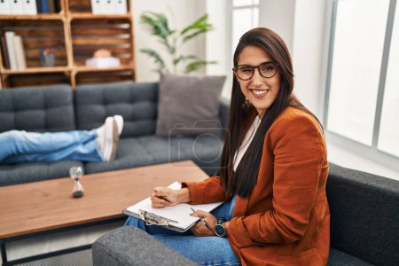 Photo for Young hispanic woman working as psychology counselor winking looking at the camera with sexy expression, cheerful and happy face. - Royalty Free Image