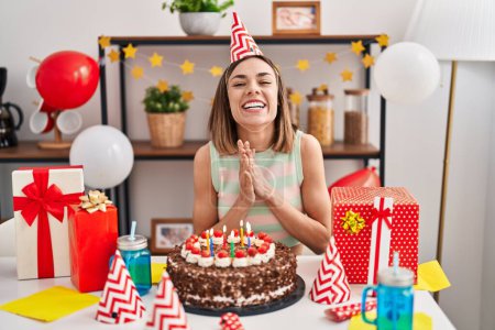 Photo for Young beautiful hispanic woman celebrating birthday sitting on table at home - Royalty Free Image