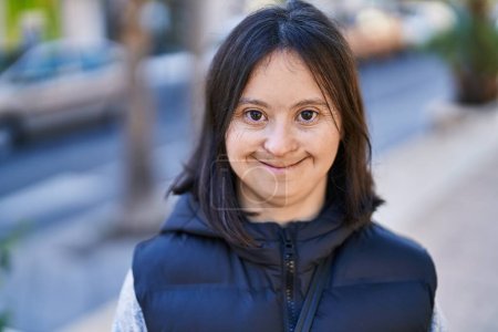 Foto de Young woman with down syndrome smiling confident standing at street - Imagen libre de derechos