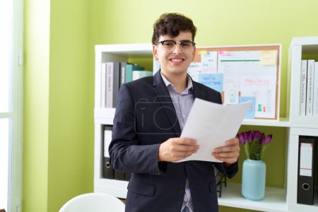 Photo for Non binary man business worker reading document at office - Royalty Free Image