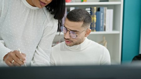 Photo for Man and woman student and teacher using computer studying at university classroom - Royalty Free Image