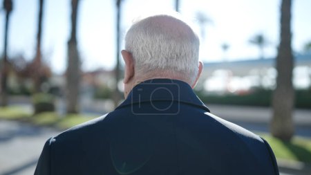 Téléchargez les photos : Senior debout vers l'arrière dans la rue - en image libre de droit