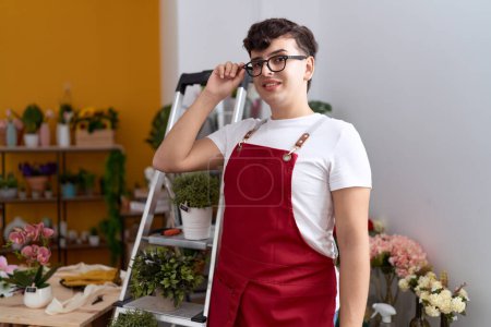 Photo for Non binary man florist smiling confident standing at flower shop - Royalty Free Image