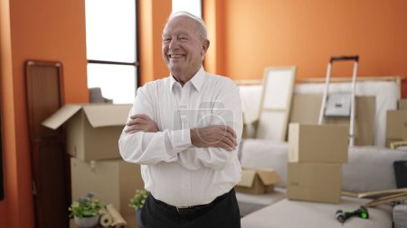 Photo for Senior smiling confident standing with arms crossed gesture at new home - Royalty Free Image