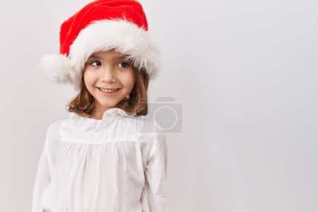 Photo for Little hispanic girl wearing christmas hat with a happy and cool smile on face. lucky person. - Royalty Free Image