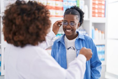 Photo for African american women pharmacist and customer wearing glasses at pharmacy - Royalty Free Image