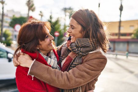 Photo for Two women mother and daughter hugging each other at street - Royalty Free Image