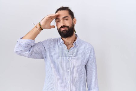 Photo for Hispanic man with beard wearing casual shirt worried and stressed about a problem with hand on forehead, nervous and anxious for crisis - Royalty Free Image