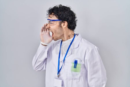 Photo for Hispanic man working at scientist laboratory clueless and confused with open arms, no idea and doubtful face. - Royalty Free Image