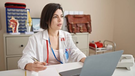 Téléchargez les photos : Young caucasian woman doctor using laptop working at clinic - en image libre de droit