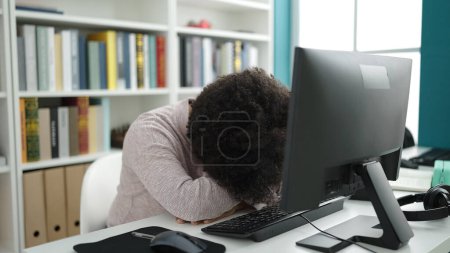 Photo for Young african american woman student using computer stressed at university classroom - Royalty Free Image