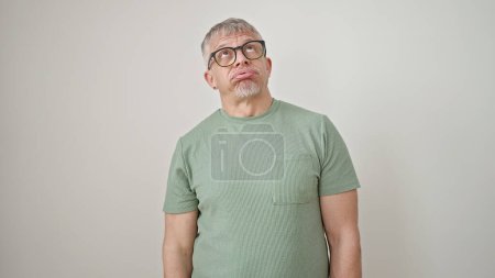 Photo for Middle age grey-haired man wearing glasses looking upset over isolated white background - Royalty Free Image