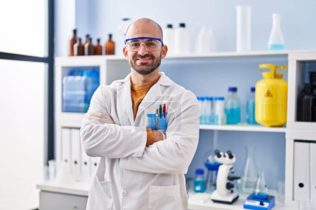 Photo for Young man scientist standing with arms crossed gesture at laboratory - Royalty Free Image