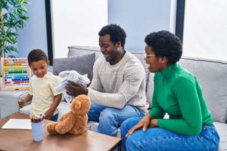 Photo for African american family playing with teddy bear at home - Royalty Free Image
